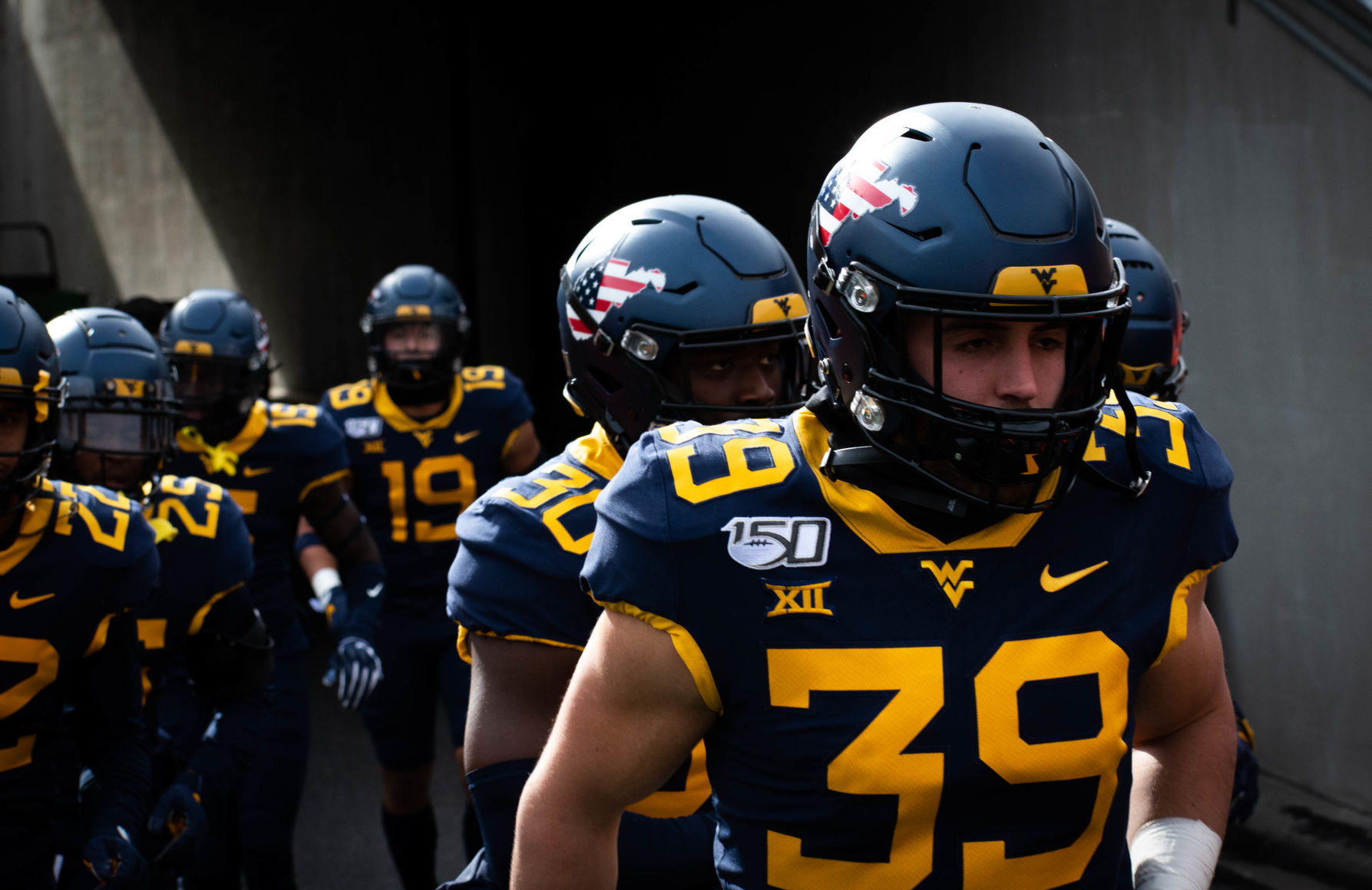 West Virginia's Dante Bonamico leads the Mountaineers out of the tunnel prior to taking on Texas Tech at Milan Puskar Stadium on Nov. 9, 2019.